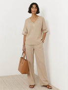 Mature woman wearing lightweight linen top with V-neck, short sleeves, and three-button front detail