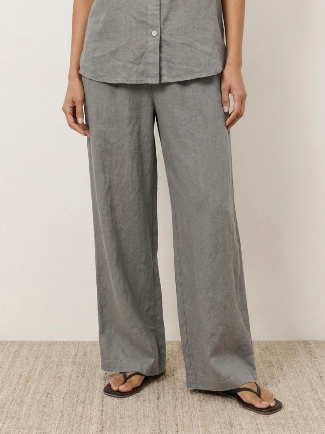 woman wearing 100% cotton navy blue two-piece set with button-front top and wide-leg pants