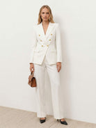 Double-breasted blazer with gold lion-head buttons and wide-leg trousers co-ord set in structured suiting fabric
