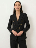 Double-breasted blazer with gold lion-head buttons and wide-leg trousers co-ord set in structured suiting fabric