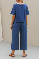 woman wearing Breezy Meadow Two-Piece Set with relaxed top and wide-leg trousers in light polyester fabric
