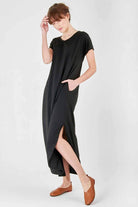 Black side slit maxi dress with pockets, V-neck, rolled sleeves, and relaxed fit.