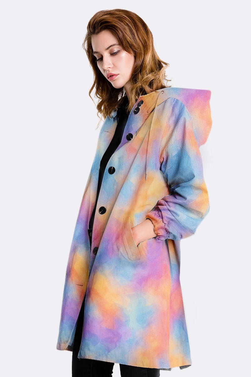 Water-resistant oversized windbreaker rain jacket with multicolor pastel design and hood on female model