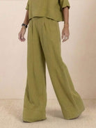 Olive green short-sleeved pullover and wide trouser matching set with loose, breathable cotton fabric and wide cuffed hem.