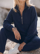 cotton-blended two-piece tracksuit with zip-front top and straight-leg pants on white background