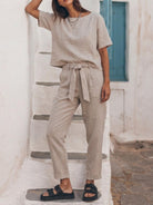 woman wearing relaxed cotton linen set with short-sleeve top and straight-leg pants in monochrome color