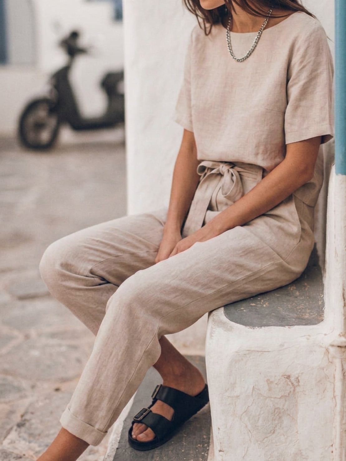 Woman wearing breathable cotton linen monochrome set with relaxed short-sleeve top and straight-leg pants