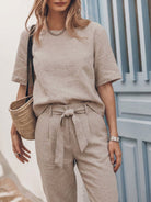 Model wearing breathable cotton linen set monochrome two-piece outfit outdoors