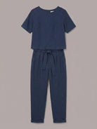 Woman wearing relaxed cotton linen set with short-sleeve top and straight-leg pants in monochrome tones