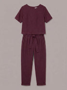 Woman wearing a relaxed cotton linen set with short-sleeve top and straight-leg pants in a monochrome palette