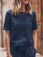 Woman wearing relaxed fit cotton linen set with short-sleeve top and straight-leg pants in monochrome tones