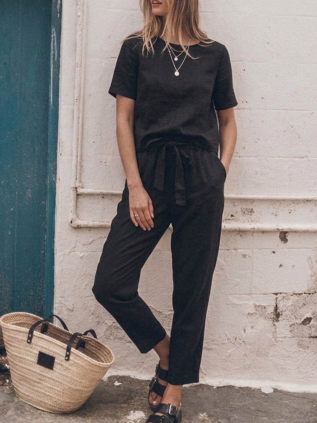 Model wearing breathable cotton linen set with relaxed short-sleeve top and straight-leg pants in monochrome tones