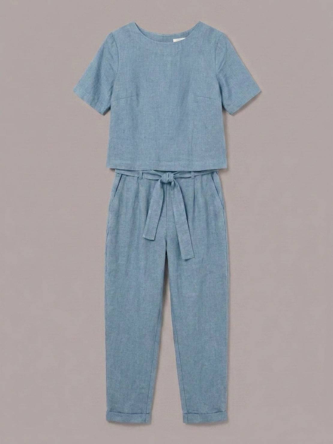 Woman wearing relaxed cotton linen set with short-sleeve top and straight-leg pants in monochrome tones