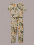 Woman wearing a breathable cotton linen set with relaxed short-sleeve top and straight-leg pants in monochrome tones.