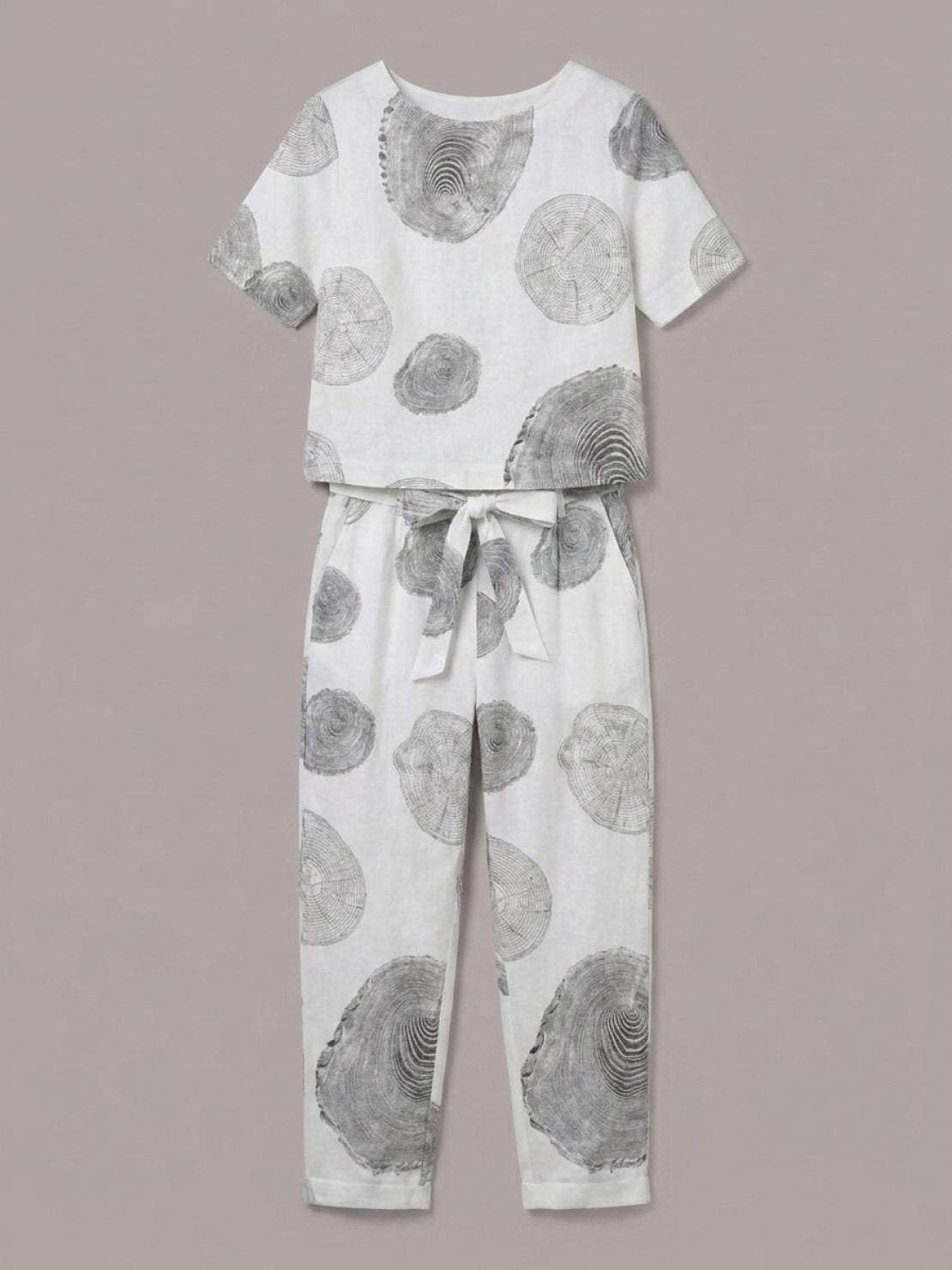 Woman wearing relaxed cotton linen set with monochrome short-sleeve top and straight-leg pants in natural texture