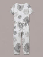 Woman wearing relaxed cotton linen set with monochrome short-sleeve top and straight-leg pants in natural texture