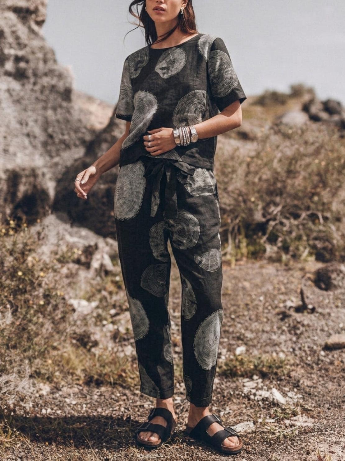 woman wearing relaxed cotton linen set with short-sleeve top and straight-leg pants in monochrome tone