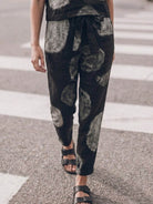 Woman wearing a breathable cotton linen set with relaxed short-sleeve top and straight-leg pants in monochrome tones