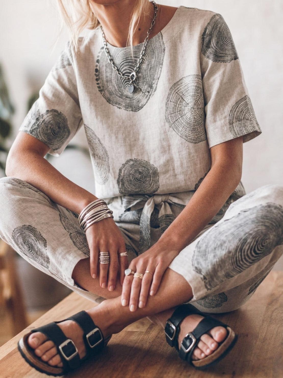 Woman wearing relaxed fit cotton linen set with short-sleeve top and straight-leg pants in monochrome tones