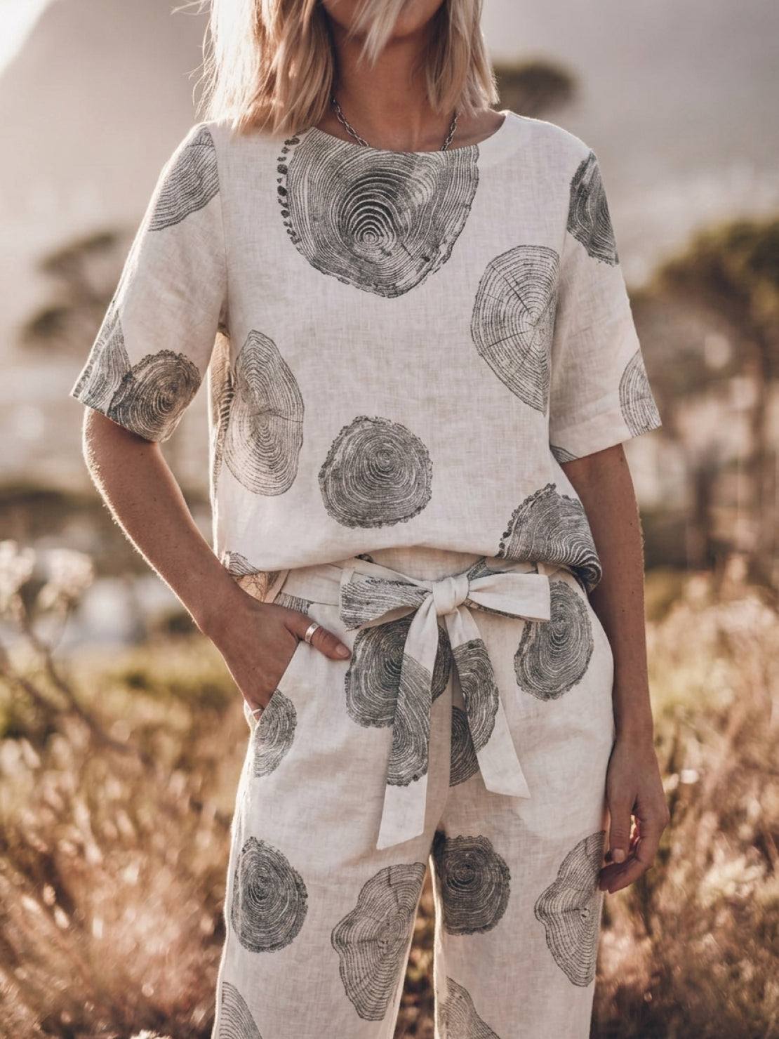 Model wearing relaxed fit cotton linen set with short-sleeve top and straight-leg pants in monochrome tones