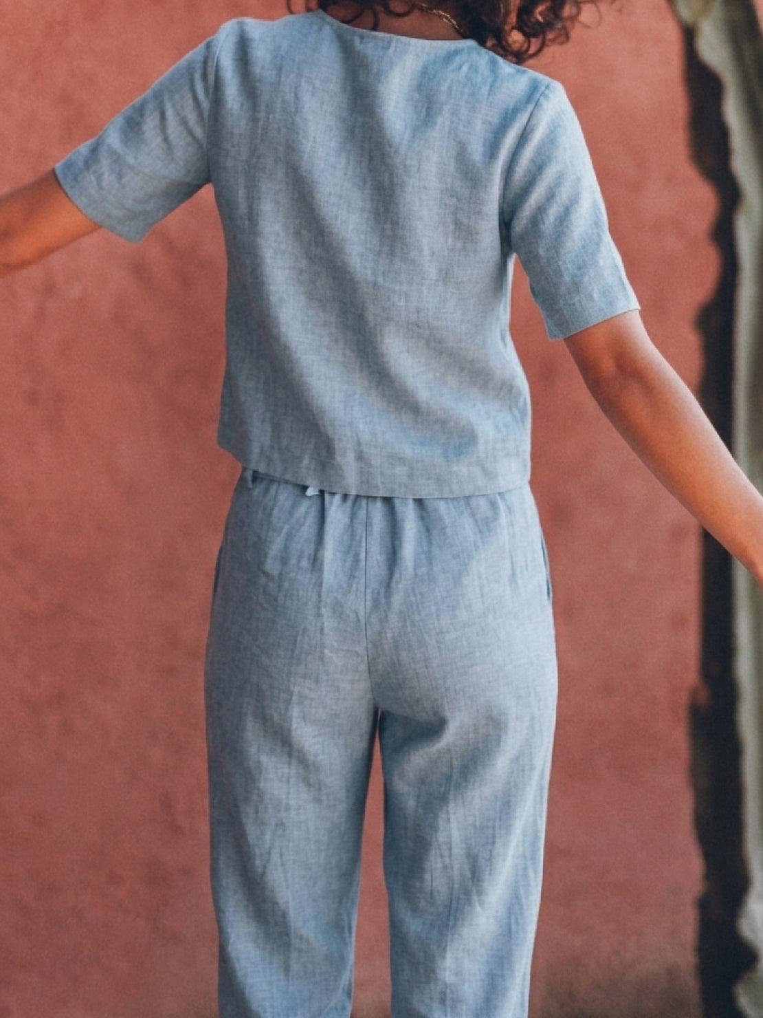 woman wearing relaxed cotton linen set with monochrome short-sleeve top and straight-leg pants