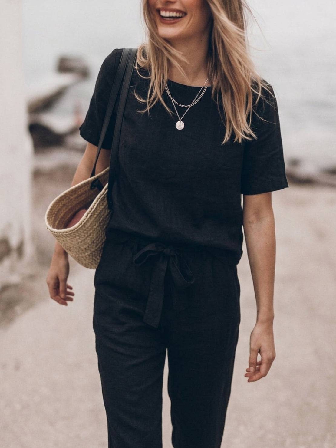 Woman wearing a breathable cotton linen set with relaxed short-sleeve top and straight-leg pants in monochrome tones
