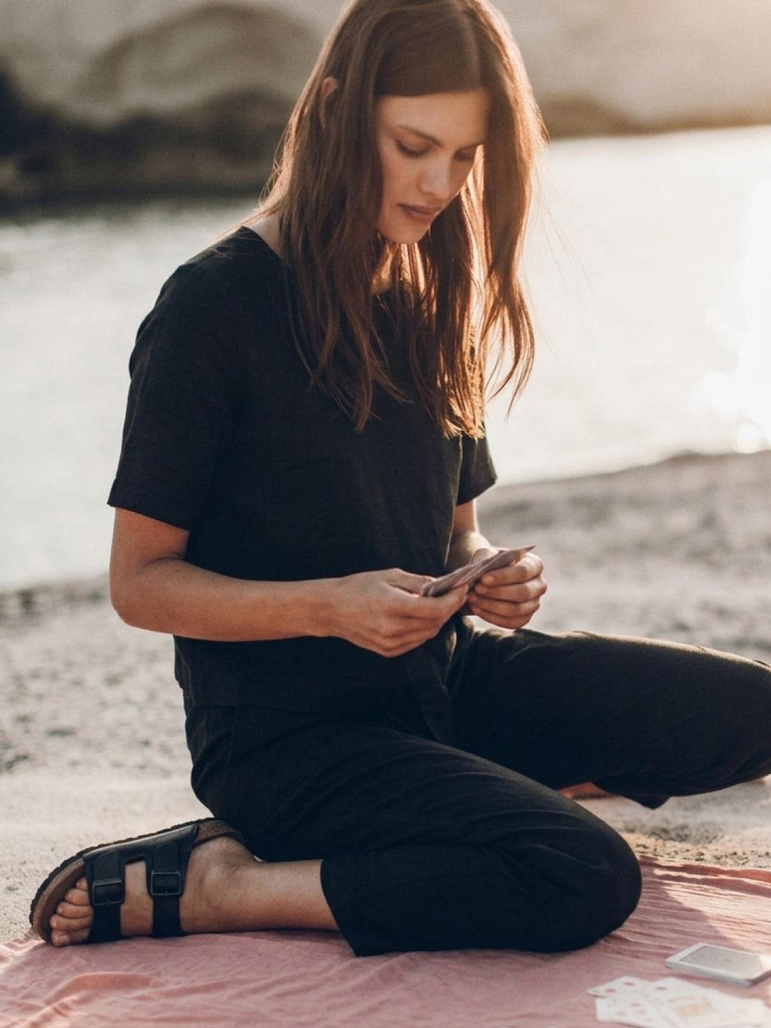 woman wearing relaxed cotton linen set with short-sleeve top and straight-leg pants in monochrome tones
