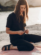 woman wearing relaxed cotton linen set with short-sleeve top and straight-leg pants in monochrome tones