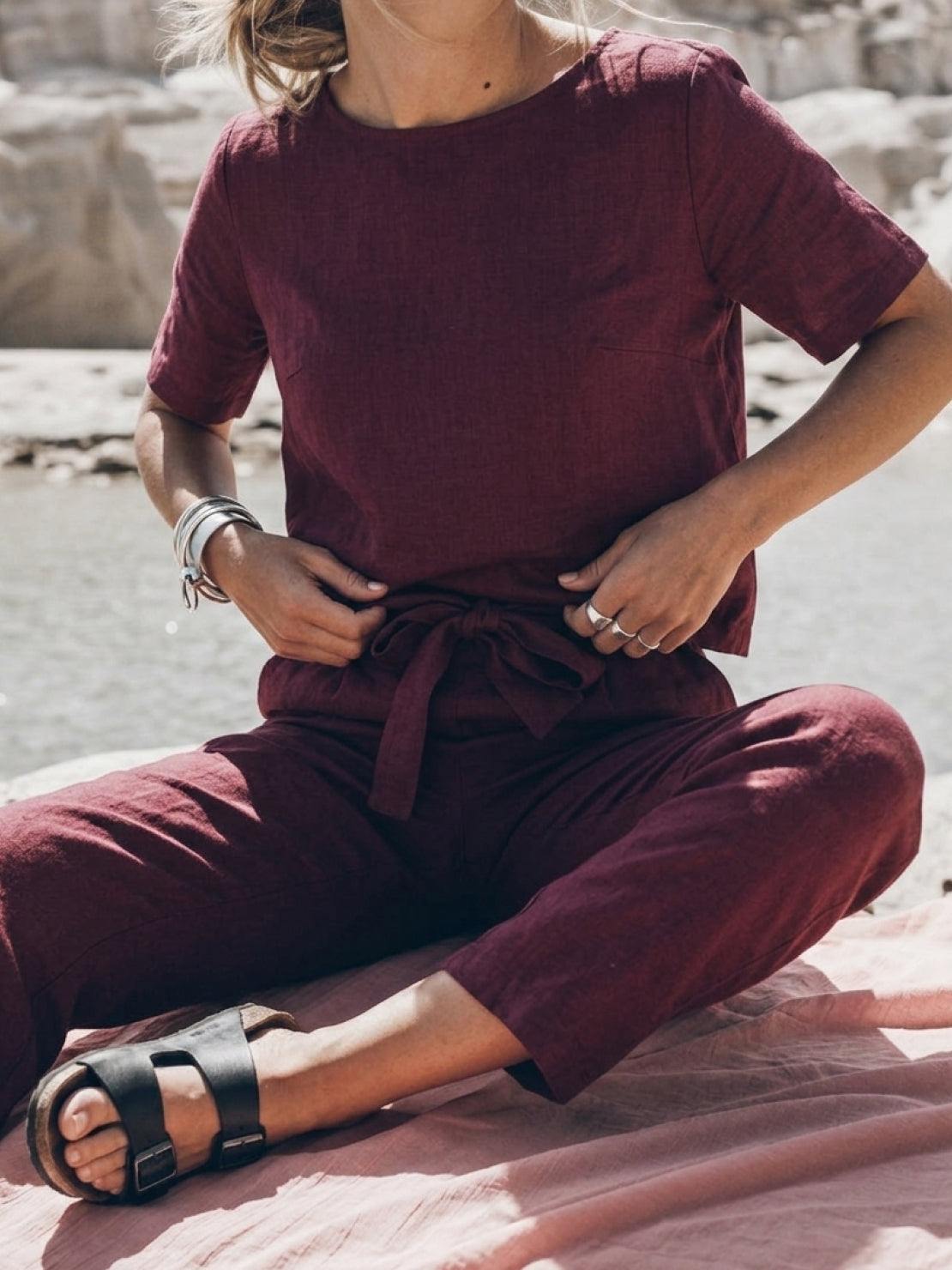 Woman wearing relaxed cotton linen set with monochrome top and pants in casual pose