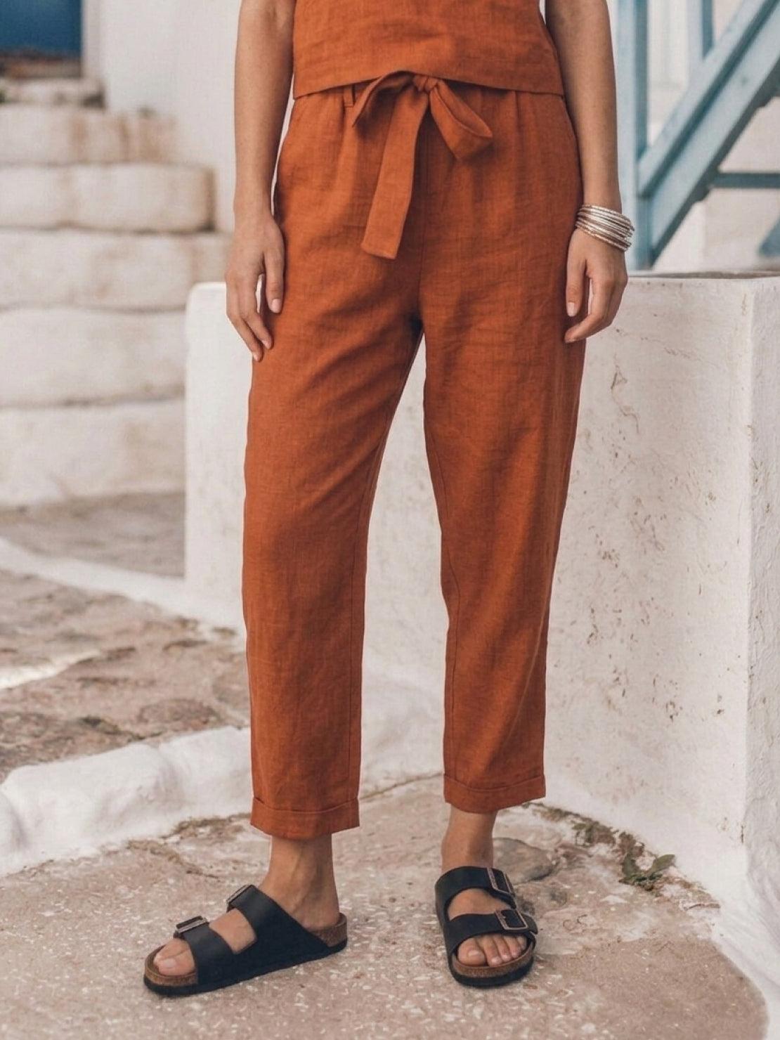 woman wearing relaxed cotton linen set with short sleeves and straight-leg pants in monochrome color
