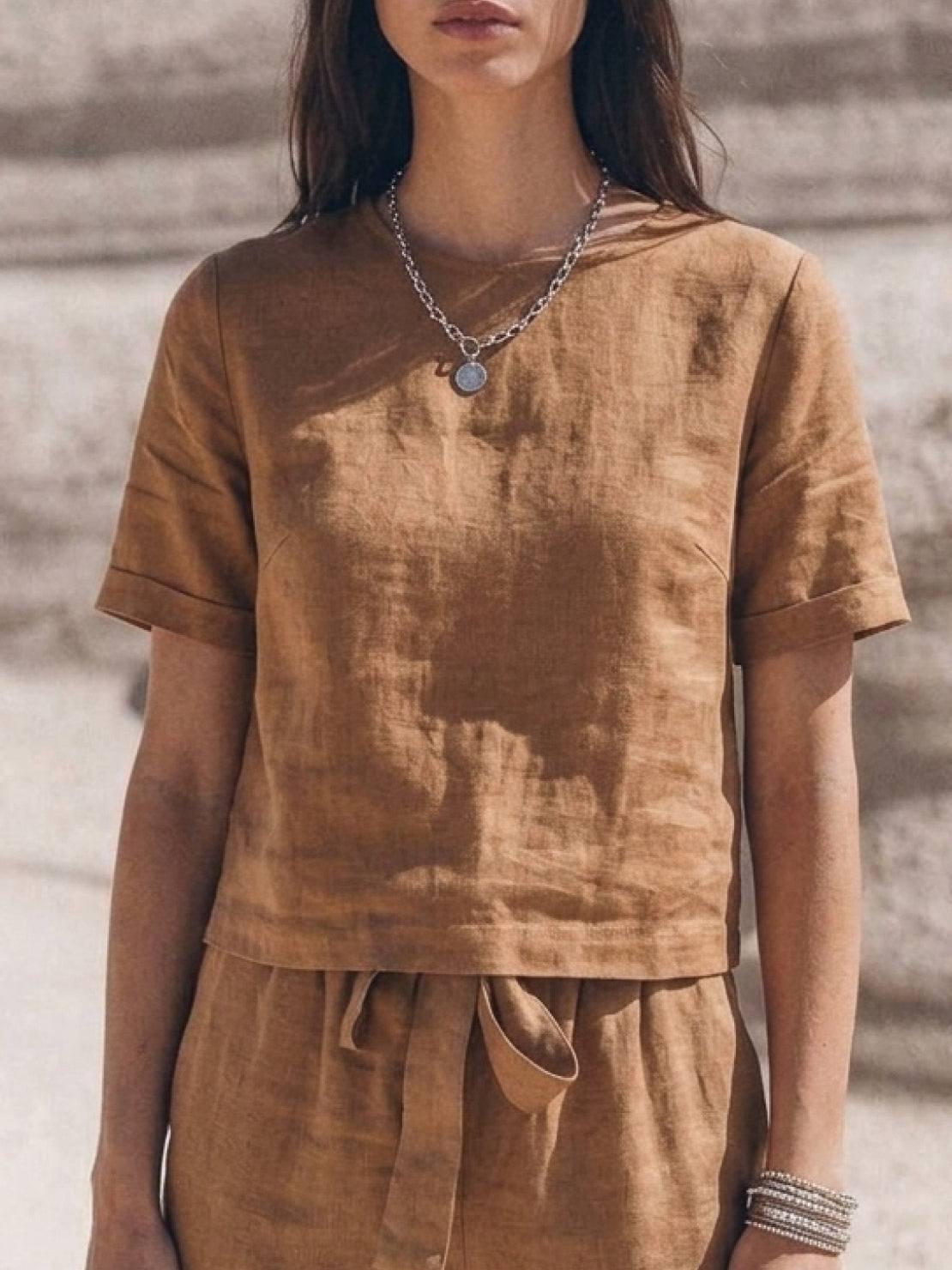 Woman wearing breathable cotton linen set with relaxed short-sleeve top and straight-leg pants in monochrome tones