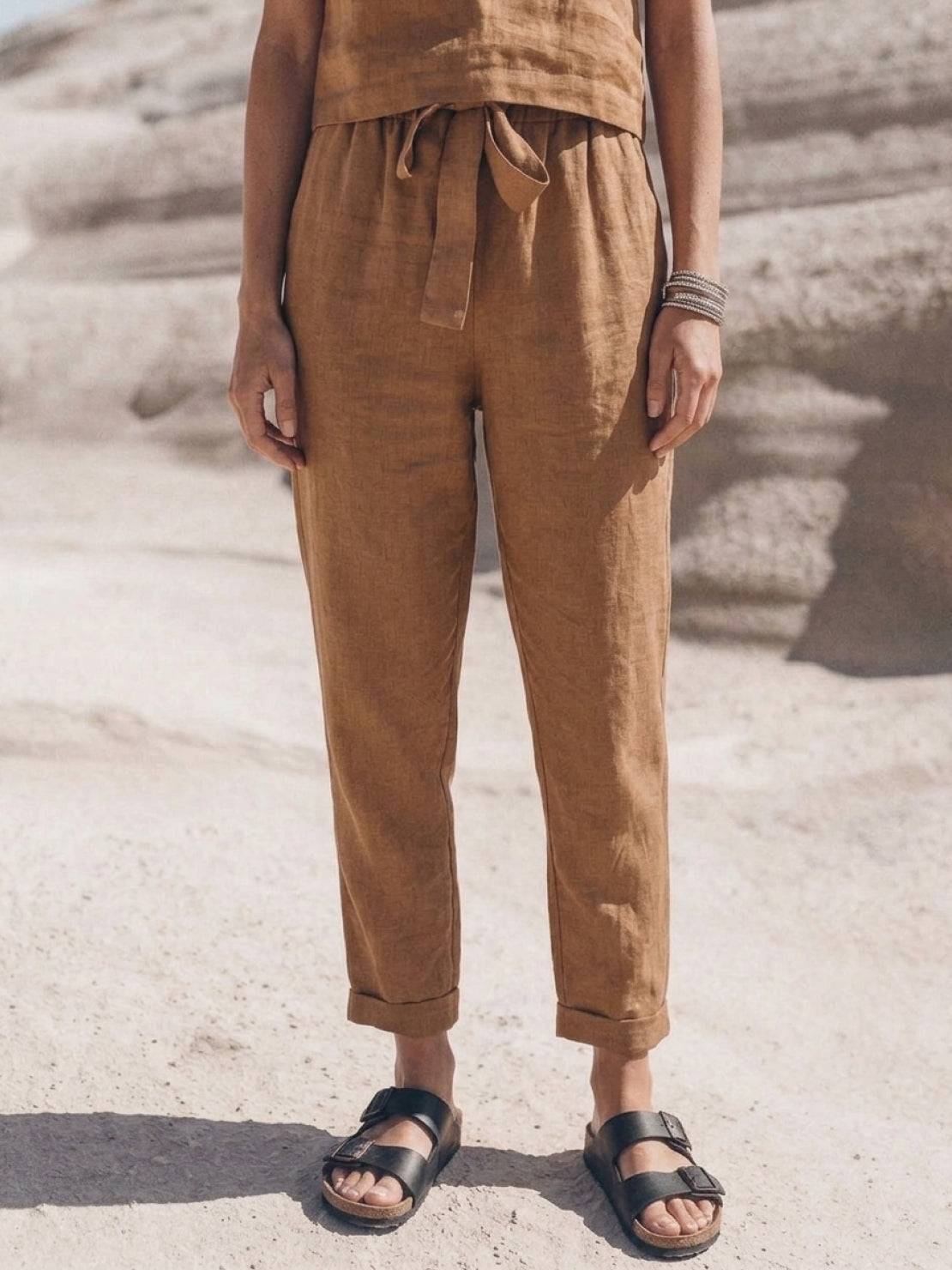 Woman wearing relaxed cotton linen set with short sleeve top and straight-leg pants in monochrome tones