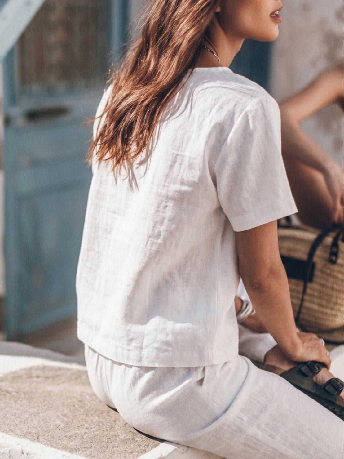 woman wearing relaxed cotton linen set with short-sleeve top and straight-leg pants in monochrome tones