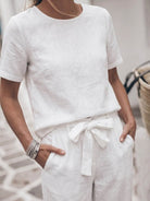 woman wearing 100% cotton linen set with relaxed short-sleeve top and straight-leg pants in monochrome color