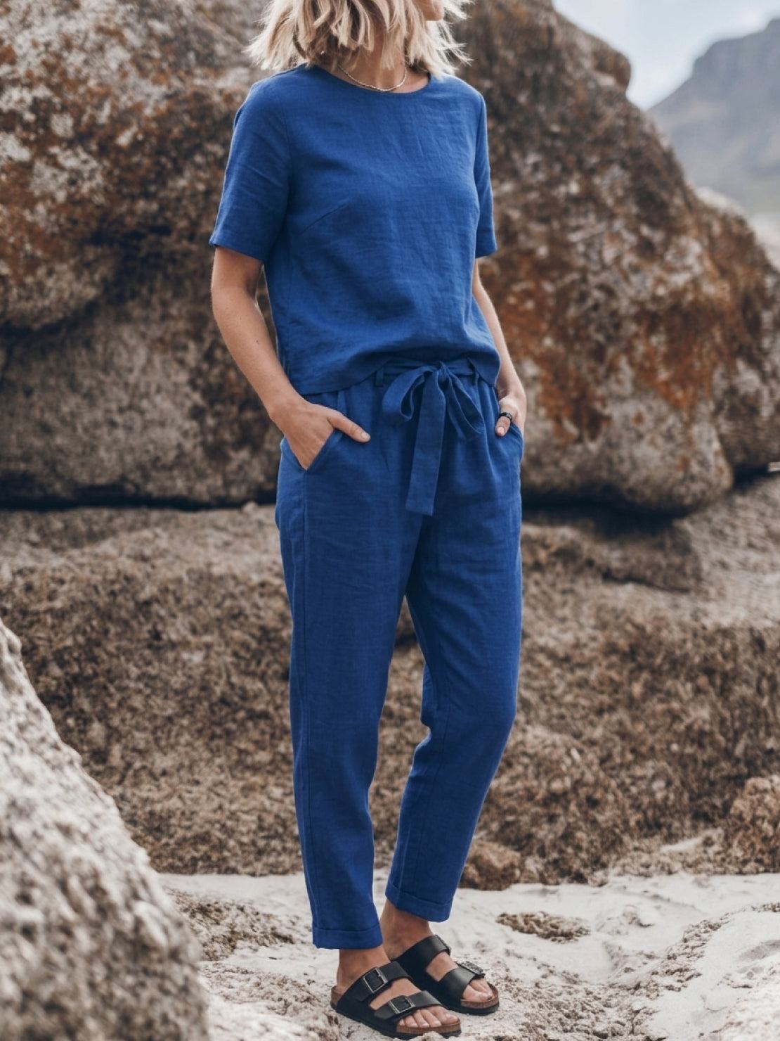 woman wearing relaxed fit cotton linen set with short sleeve top and straight-leg pants in monochrome color