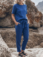 woman wearing relaxed fit cotton linen set with short sleeve top and straight-leg pants in monochrome color