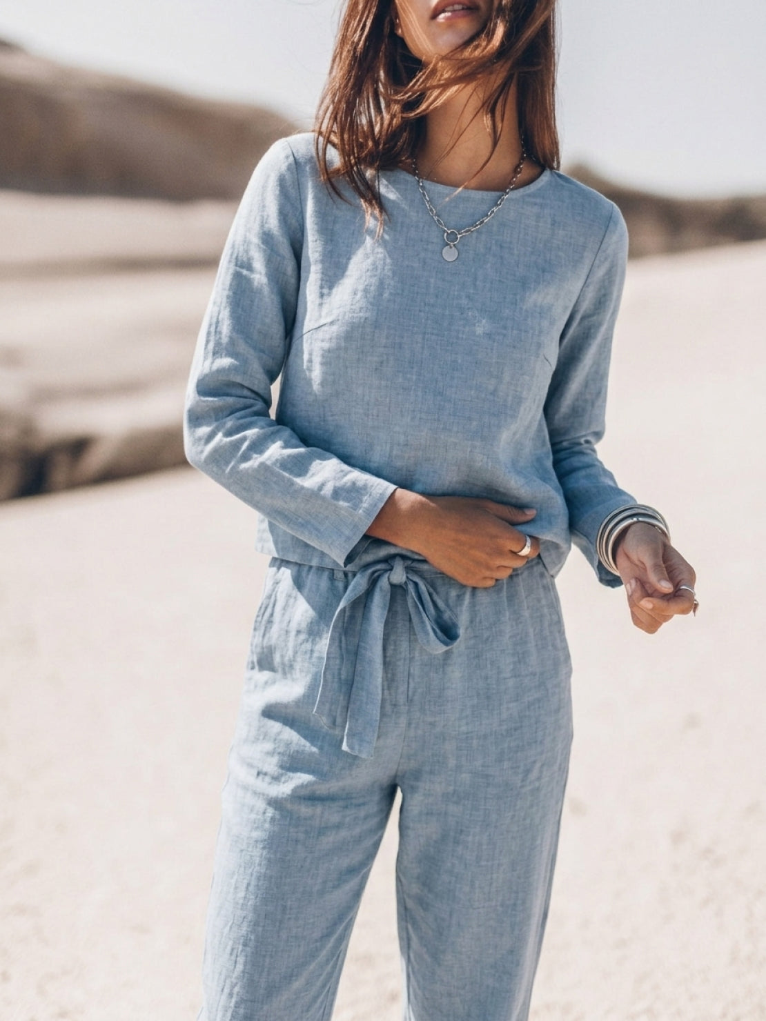 Woman wearing cotton-linen monochrome relaxed two-piece set with longline top and wide-leg pants