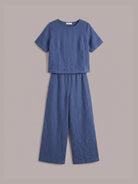 Woman wearing a soft cotton loose fit co-ord set with wide sleeves and wide-leg trousers in relaxed style