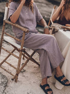 woman wearing loose fit co-ord set with soft-tailored top and wide-leg bottoms in light cotton fabric