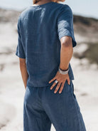 Woman wearing soft-tailored loose fit co-ord set with wide-leg cotton trousers in light fabric