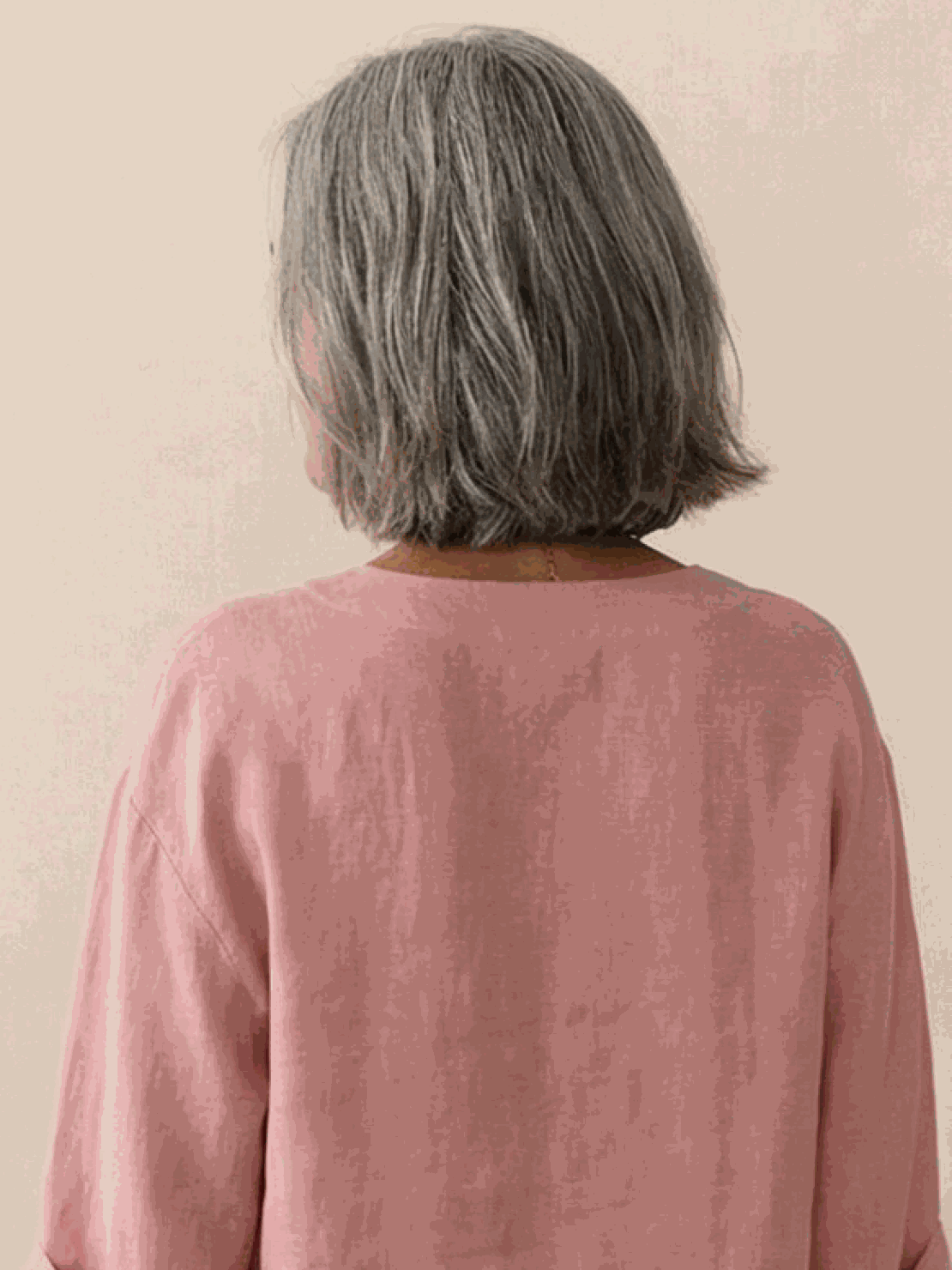 white pure linen age-defying shirt with button detail on hanger against white background