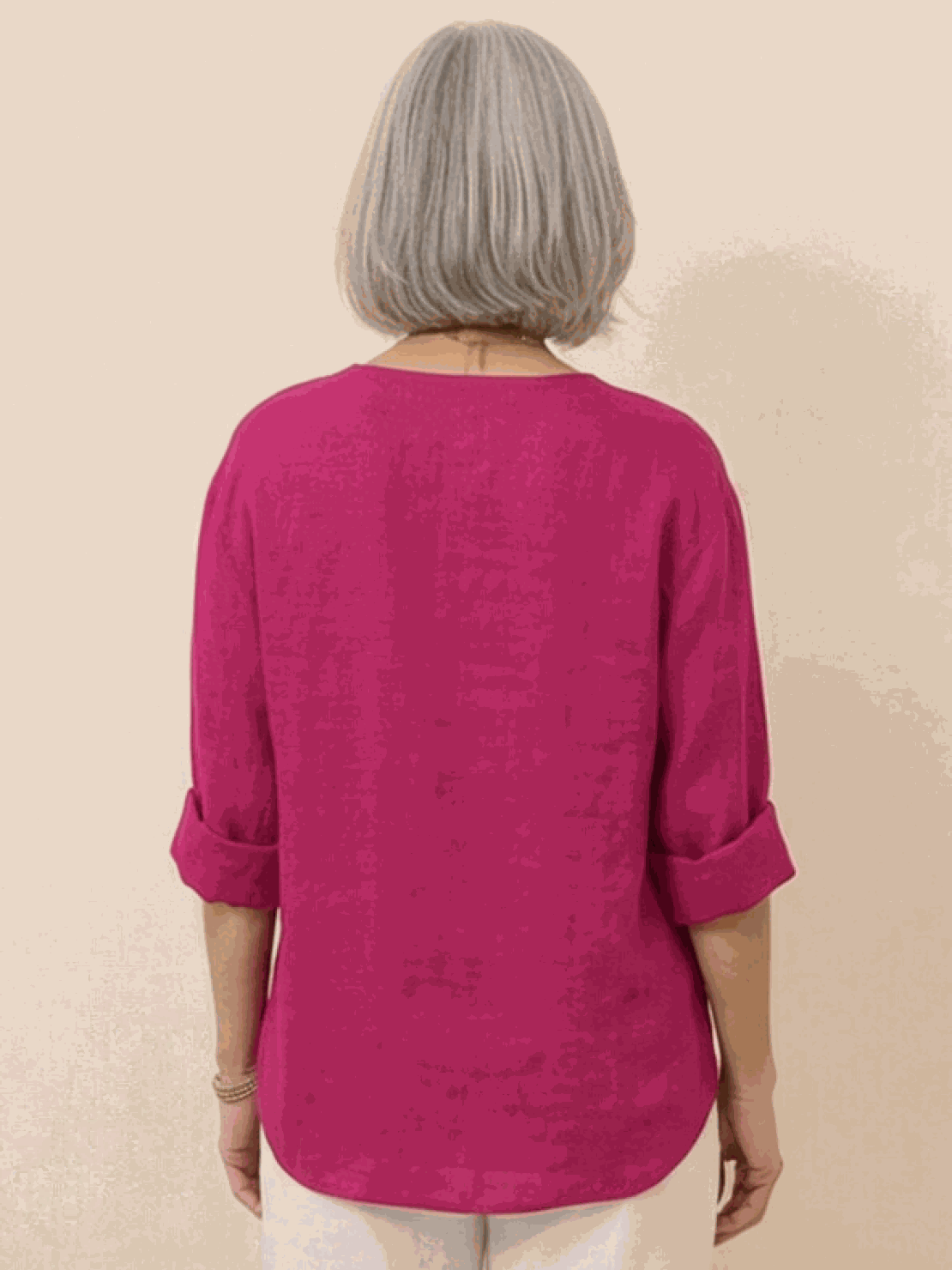 White pure linen age-defying shirt with button details on hanger against white background