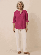 white pure linen age-defying shirt with button details on wooden hanger