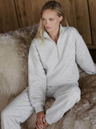 Woman wearing cotton-blended two-piece tracksuit with high collar and deep zipper outdoors