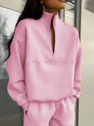 Woman wearing cotton-blended two-piece tracksuit with high collar and deep zipper outdoors