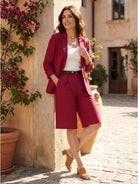 Woman wearing a stylish blazer and high-waisted shorts two-piece set in durable cotton-terylene blend