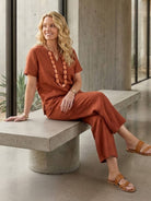 Woman wearing breezy cotton blend two-piece set with short sleeves and elastic waist pants standing outdoors