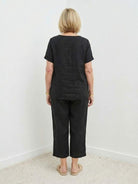 Woman wearing breezy cotton blend two-piece set with short sleeves and elastic waist pants