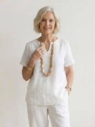 Women wearing breezy cotton blend two-piece set with short-sleeve shirt and elastic waist pants