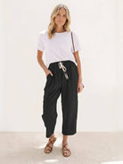 Women wearing breezy relaxed fit straight pants in various colors showcasing comfort and style